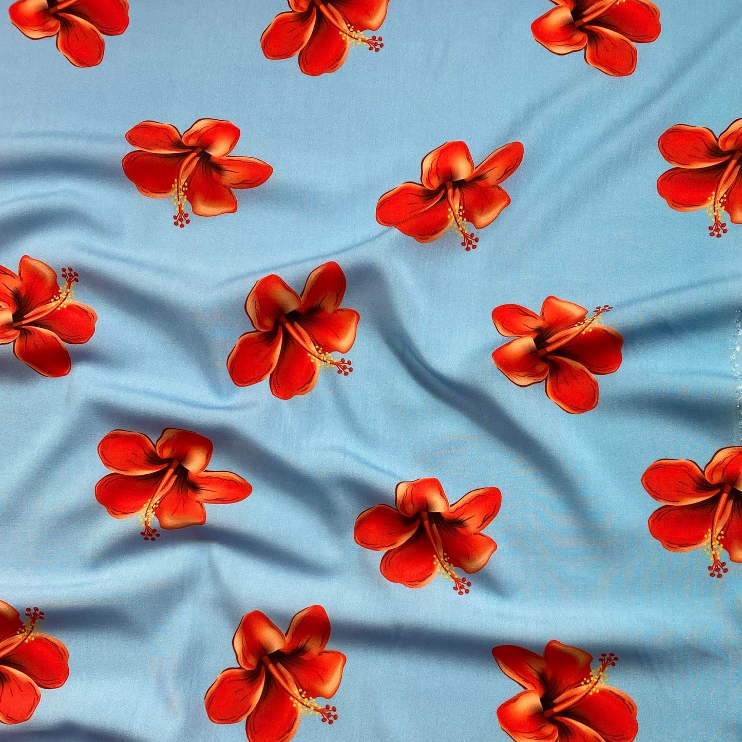 Popelina azul bebé con flores