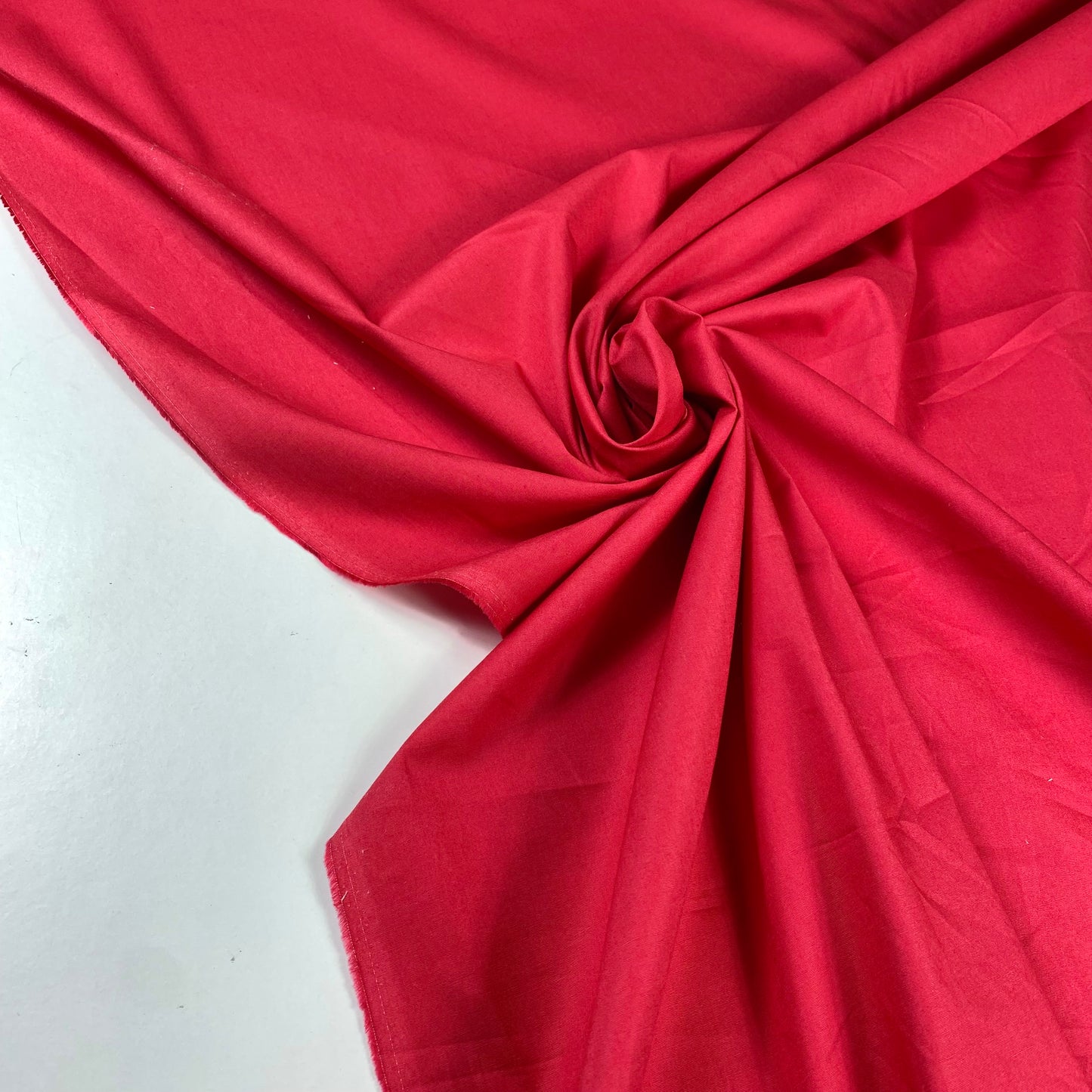 Red poplin with some elastane.