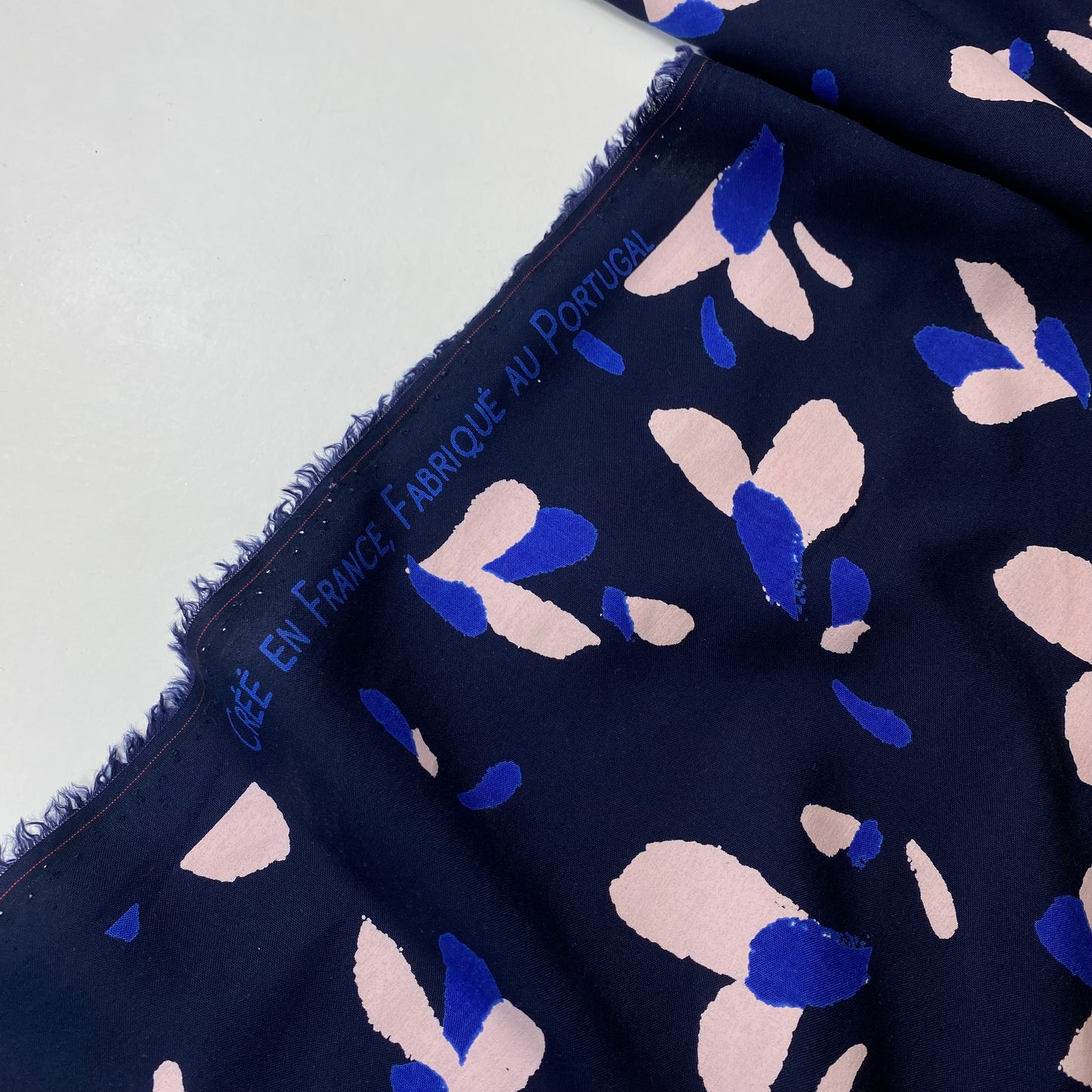 Navy blue poplin with blue and salmon details.