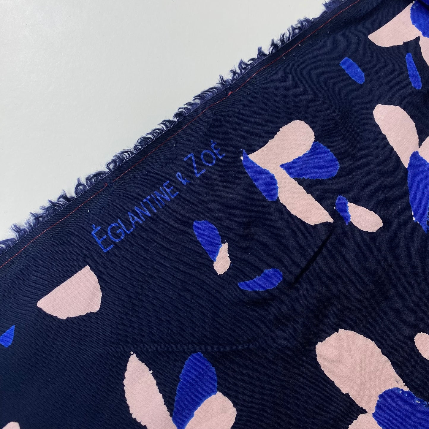 Navy blue poplin with blue and salmon details.