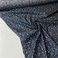 Navy blue poplin with orange, blue, and beige spots.