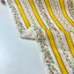 Tela chintz de Alcobaça con rayas blancas y amarillas y cenefas florales.