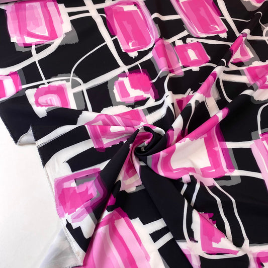 Tejido de punto interlock negro con motas rosas