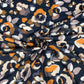 Black viscose jersey with orange and cream flowers