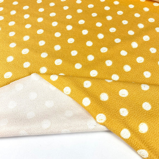 Yellow embossed mesh with white dots